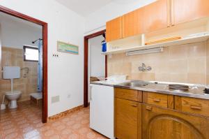 a kitchen with a sink and a toilet at Apartments Laura in Dramalj +51 photos