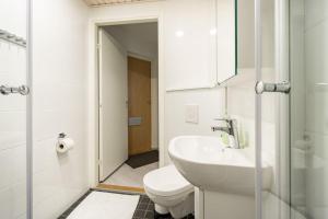 a white bathroom with a toilet and a sink at Haven Homes, Nordic Haven in Rovaniemi +28 photos