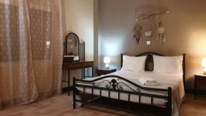 a bedroom with a bed and a mirror at Andreas&Dinas sweet home in Corfu