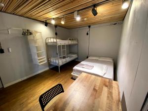 una habitación con una mesa y una cama en ella en Itaewon Inn, en Seúl