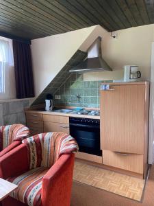 a kitchen with a stove and a stove top oven at Haus Petra in Stadtkyll