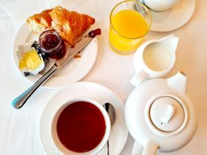 a table with a plate of food and a cup of coffee at St Moritz Hotel and Cowshed Spa in Polzeath