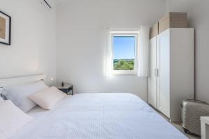 Postel nebo postele na pokoji v ubytování SEA VIEW-STONE HOUSE APARTMENT