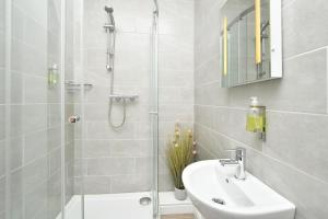 a white bathroom with a shower and a sink at The Victoria in Newcastle under Lyme +37 photos