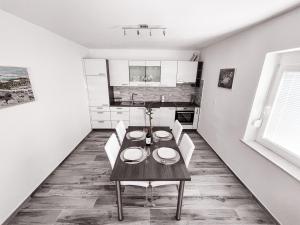 a dining room table and chairs in a kitchen at RIAD Apartments Premium in Zgornje Škofije