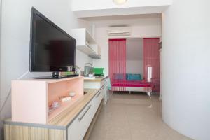 a living room with a flat screen tv on a cabinet at Apartments Vesela in Podaca