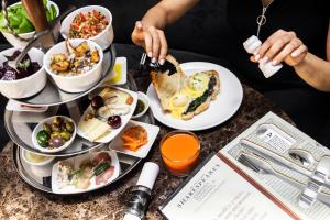 a table with plates of food on a table at Backstage Hotel - an Atlas Boutique Hotel in Tel Aviv