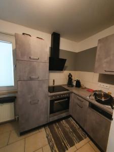 a kitchen with stainless steel appliances and a sink at Schlaf bei Arty in Leverkusen