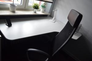 a black chair sitting in front of a desk at Apartment in the City Center - FREE PARKING - easy check-in in Chorzów