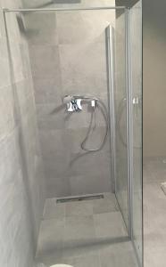 a shower with a glass door in a bathroom at Apartment Sun Lakes - Sever in Senec