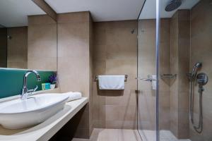 a bathroom with a shower, sink, and tub at Angela Hotel Downtown Rooms in Rhodes Town