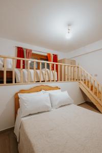 a bedroom with a bed and two bunk beds at Panoramic Vlachos in Gjirokastër