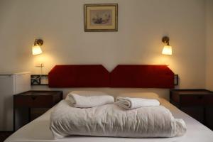 a bedroom with a bed with two towels on it at Jerusalem Hostel in Jerusalem