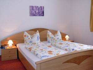 a bedroom with a bed with pillows on it at Ferienpension Gabriele 15 in Kurort Gohrisch