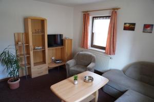 a living room with a couch and two chairs and a table at Ferienpension Gabriele 15 in Kurort Gohrisch