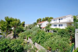 een wit gebouw op een heuvel met bomen bij Apartments BJ in Marina