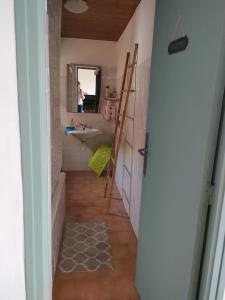 a small bathroom with a sink and a mirror at Vacances près de Saint Florent in Olmeta-di-Tuda