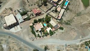 an aerial view of a house with trees and a road at Relais Esmeralda in Lalla Takerkoust