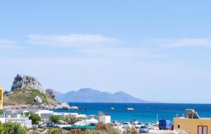 a view of a town and the ocean at Zafira Studios in Kefalos