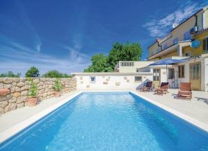 a swimming pool in front of a house at Villa ERIN in Crikvenica