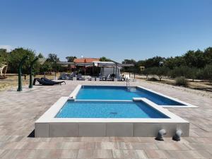 a swimming pool in the middle of a patio at Grande Glamping with Pool in Biograd na Moru