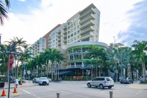 a large building on a city street with cars at Lovely Condo At Midtown Miami with pool in Miami
