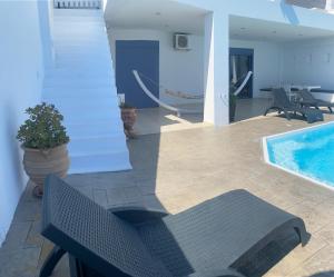 The swimming pool at or close to NV seafront villa Aegina 1