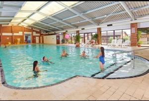 a group of people in a swimming pool at Coastal Chalet Retreat in St Margaret's Bay in St Margarets at Cliff