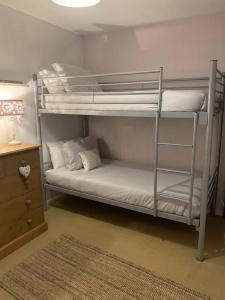 a bedroom with two bunk beds and a desk at Coastal Chalet Retreat in St Margaret's Bay in St Margarets at Cliff +13 photos