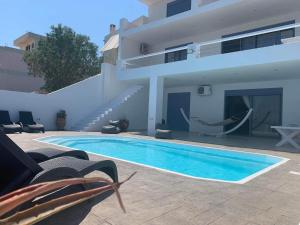 The swimming pool at or close to NV seafront villa Aegina 1