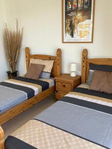 a bedroom with two beds and a picture on the wall at Coral Bungalow in Coral Bay +40 photos