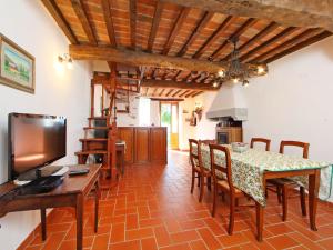 a kitchen and dining room with a table and chairs at Apartment Piano Rosso 1 by Interhome in Marradi