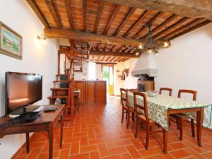 a kitchen and dining room with a table and chairs at Apartment Azienda Agricola Piano Rosso-1 by Interhome in Marradi