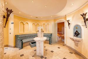 a bathroom with a sink in the middle of a room at Burghotel Staufeneck in Salach +42 photos