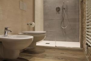 a bathroom with a shower and a toilet and a sink at Pedrin's House in Livigno +3 photos