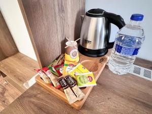 a tray with food and a coffee maker and a bottle of water at Nira Boutique Hotel in Ankara