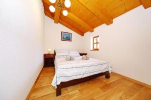 a bedroom with a bed and a wooden ceiling at House Flamingo in Pašman