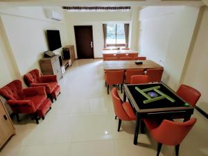 a dining room with a table and red chairs at 礁溪幸福民宿Jiaoxi Happy Homestay in Jiaoxi