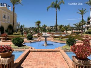 a large pool of water in front of a large building at Aloha Gardens by Vacation Care in Marbella