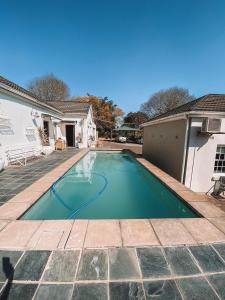 a swimming pool in the backyard of a house at Ebony Lodge in Mthatha