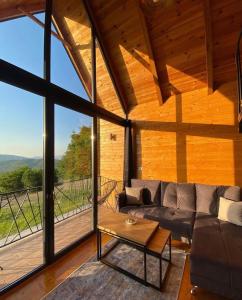 a living room with a couch and a large window at Woodhouse in Bijelo Polje +27 photos
