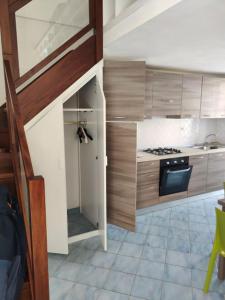 a kitchen with a sink and a stove top oven at VisitPonza - La tana di Bacco in Ponza