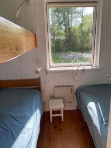 Ένα ή περισσότερα κρεβάτια σε δωμάτιο στο Sommerhus - Bratten strand