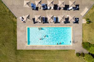 an overhead view of a pool with people swimming at Spinerola Hotel in Cascina & Restaurant UvaSpina in Moncalvo