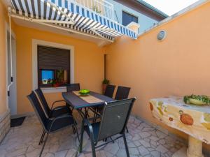a patio with a table and chairs and a dining room at Villa Lara in Jadranovo