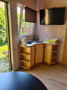 a small kitchen with a sink and a tv at u Anny Pionierów 8B in Mielno