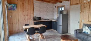 a kitchen with a table and chairs in a room at Cabaña La Puntilla in Vichuquén