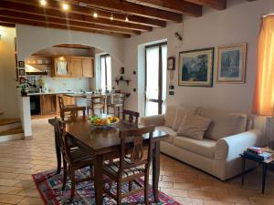 a living room with a table and a couch at Villa Panorama in Gargnano