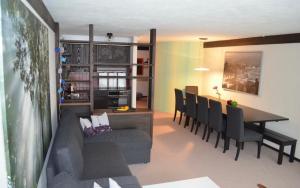 a living room and dining room with a table and chairs at Ferienwohnung Engelberg in Engelberg