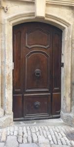 a large wooden door on the side of a building at Maison Passère in Forcalquier